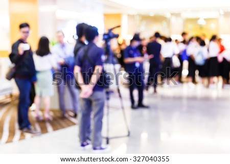 Abstract blurred people in press conference room, business concept, official new product launches