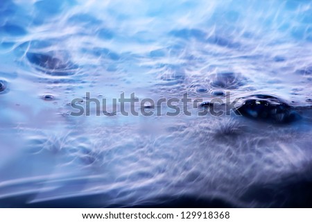 Abstract waves and bubbles. macro shot of blue liquid soap
