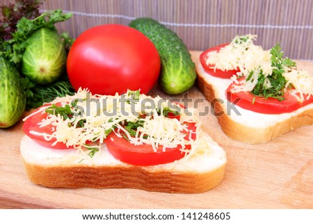 vegetarian sandwich with tomato, cheese and greens