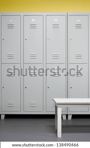 Row Of Steel Lockers With White Bench