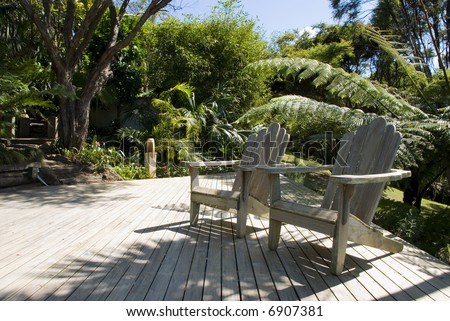 two deck chairs to relax in on a deck in gardens while enjoying the summer sunshine