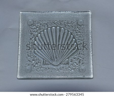 Scallop shell nautical glass drink coaster decor on a dinner table