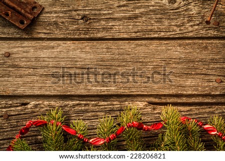 Rustic Christmas Background - Aged Barn Wood with Pine Tree Branch with Red Garland