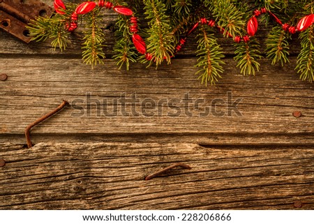 Rustic Christmas Background - Aged Barn Wood with Pine Tree Branch with Red Garland