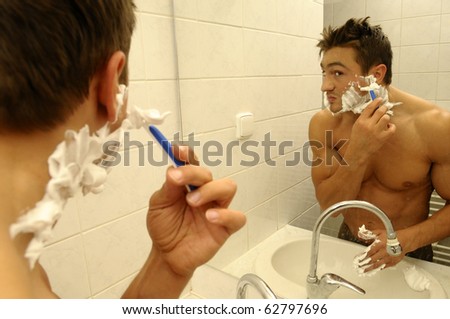 A shaving man in the mirror