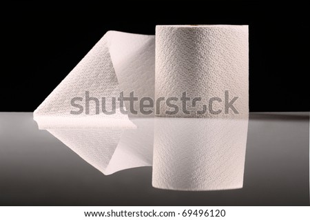 Roll of tissue paper on desk with reflection