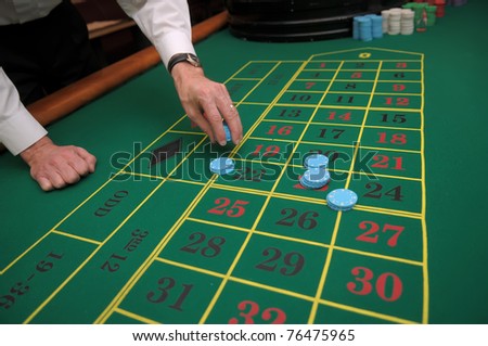 Picture of a green table and betting with chips