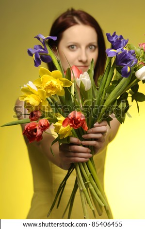Portrait of pretty girl with a bunch of flowers