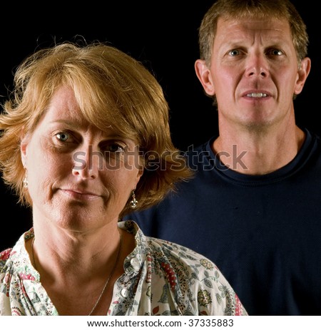 Angry, disapproving parents - how a son or daughter might see them after breaking a rule (or: a couple showing irritation, skepticism), focus on woman