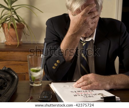 Businessman with bad sales report, drinking alone, showing frustration and anxiety