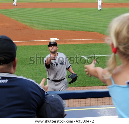 ATLANTA - JUNE 24: New York Yankees star pitcher Joba Chamberlain tosses baseball to a young fan before starting a game against the Braves on June 24, 2009 in Atlanta