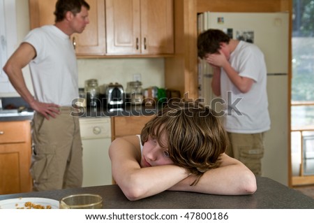 Family fight - young son feel sad as father yells at his brother