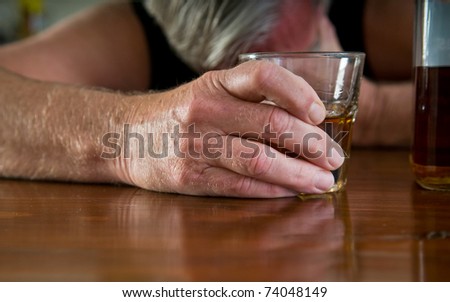 alcoholism - depressed man with whiskey