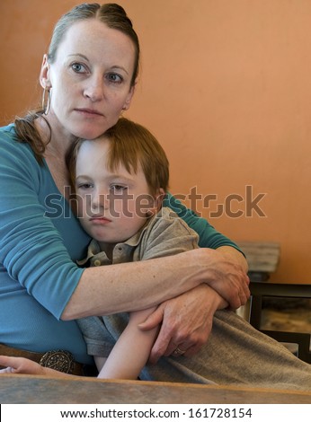 Mother hugging her sad 6-year old son