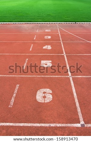 Start point of running track with green grass