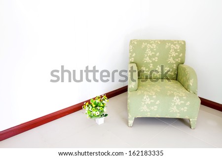 Green sofa on the white corner in the house