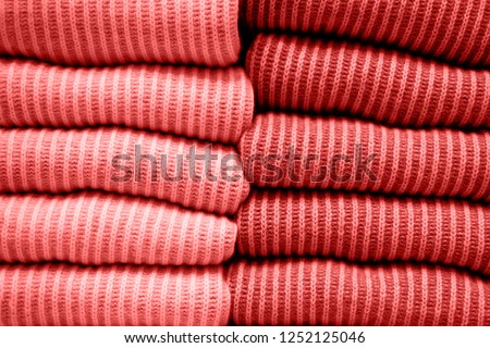 Trend photography on the theme of the new color of the year 2019 - Living Coral. Handmade knitting wool texture background of New trending Living Coral color
