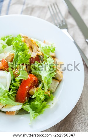 Caesar salad with chicken, cherry tomatoes, lettuce