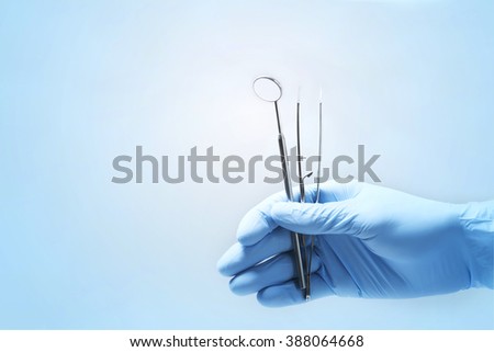 Close-up of dentist's hands and dental equipment