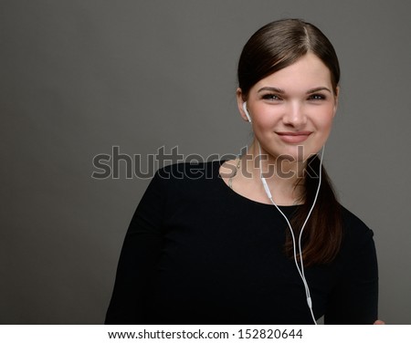 Beautiful sexy girl listening to music or talking on the phone with headphones
