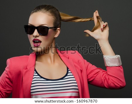 Beautiful Girl In Sunglasses Holds The Own Hair And Twists Them And Talking