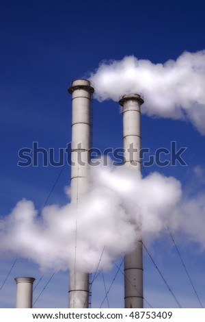 Factory tubes against blue sky