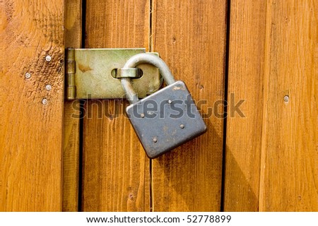 Padlock on wooden background
