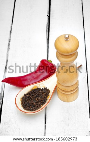 Paprika and pepper shaker on wooden table