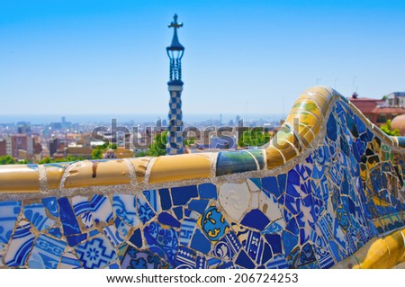 BARCELONA, SPAIN - JUN 11, 2014:  Ceramic mosaic Park Guell  in Barcelona, Spain. Park Guell is the famous architectural town art designed by Antoni Gaudi and built in the years 1900 to 1914