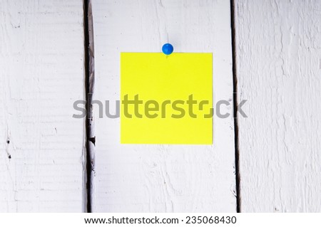 Yellow memo pad on the wooden board