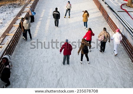 MOSCOW, RUSSIA - NOVEMBER 29, 2014: People at Skating rink on VDNKh (All-Russia Exhibition Centre), Moscow, Russia. It  is the largest ice rink in the world