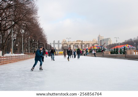 MOSCOW, RUSSIA - February 23, 2015: People at Skating rink in The Central Park of Culture and Rest named after Maxim Gorky in Moscow. Park is a largest in Moscow was  established in 1928.