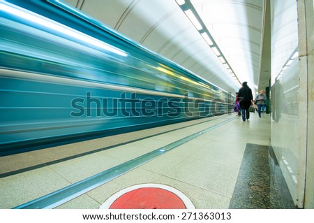 MOSCOW, RUSSIA - APRIL 17, 2015: Moving train and passengers  in subway station Mendeleevskaya in Moscow, Russia