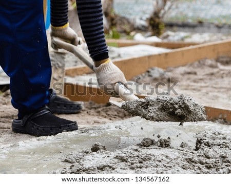 Construction worker mixing cement