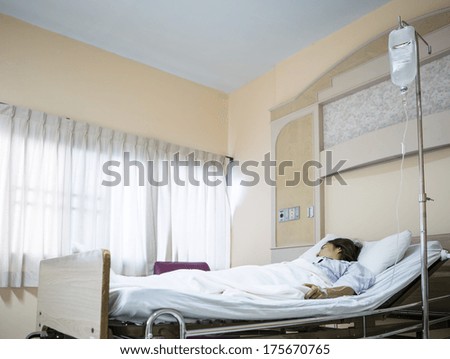Woman patient in hospital bed Woman patient in hospital bed