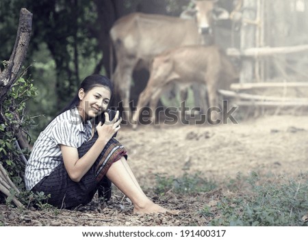 Thai Young Woman Holding Radio in farm (Vintage Color)