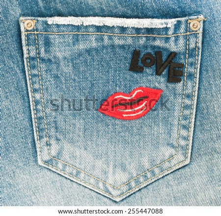 Blue jeans pocket with lip and love word