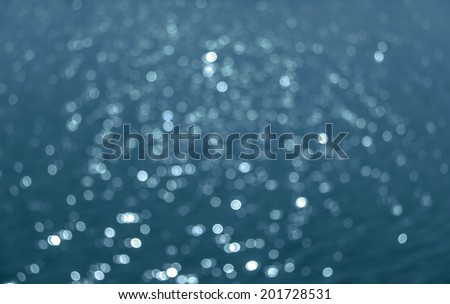 Abstract circular bokeh background of Light shining on the river, Abstract river shot in manual mode out of focus. Dark blue color.
