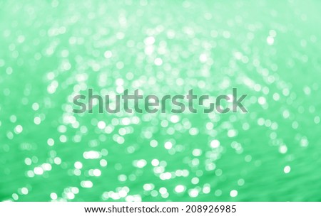Abstract circular bokeh background of Light shining on the river, Abstract river shot in manual mode out of focus.Green color.