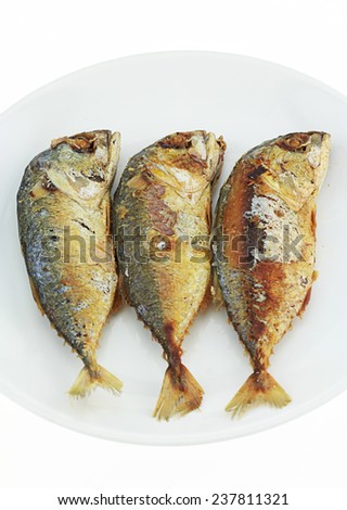 3 Fried Mackerel on white background , burnt and scorched cancer cause.