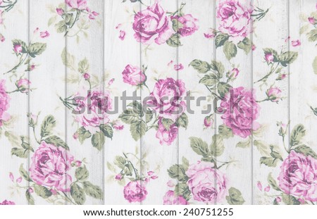 pink rose vintage from fabric on white wooden background.