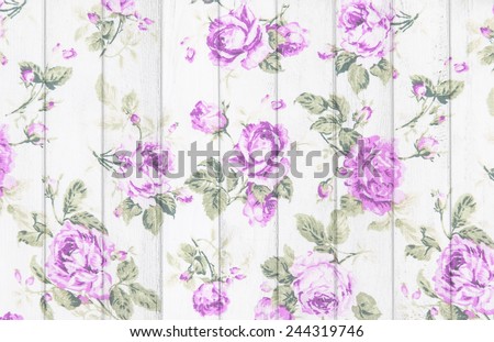 purple rose vintage from fabric on white wooden background.