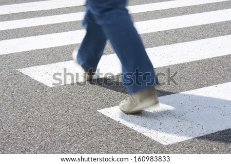 a pedestrian while crossing the road at the pedestrian crossing