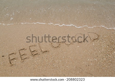 text Feel Good on the sandy beach.