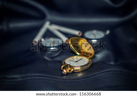 Pocket watch isolated on leather background.