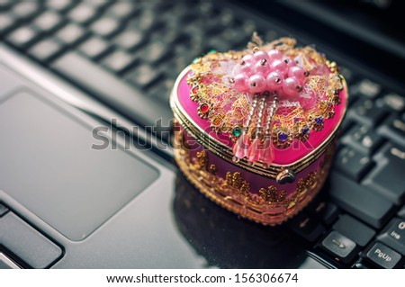 Pink casket on keyboard background.