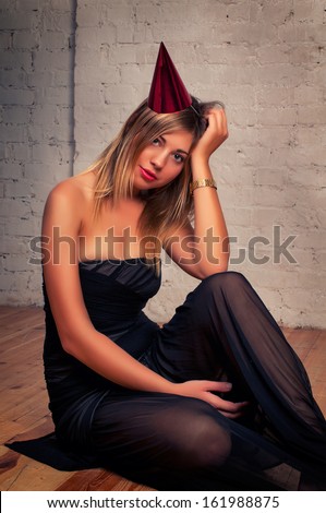 Fashion woman portrait in black dress holding a gift.