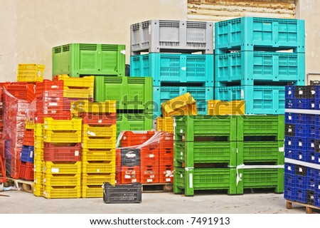 Coloured stacks of fruits and vegetable crates in a storehouse