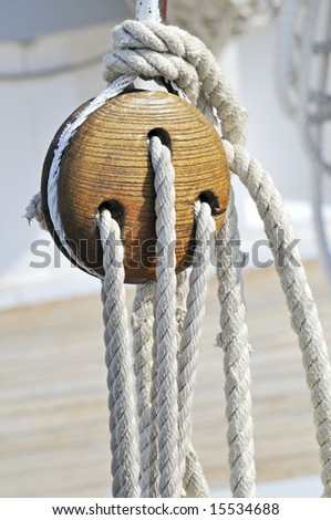 Close-up of a vintage boat: wooden block and ropes