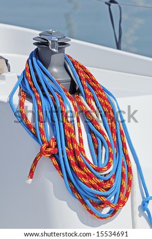Colored ropes wrapped on a winch of a boat